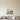 Black steel coastline wall art with a lighthouse on a cliff and two sailboats on curling waves