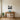 Lighthouse and sailboats metal wall art hanging above a sofa in a living room