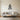 Lilac line metal wall art hanging beside a dresser in a bedroom