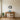 Mountain lake reflection metal wall art hanging above a sofa in a living room