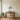Ocean wave line art above a living room sofa
