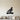 Black metal wall art of a pigeon standing on a ledge