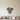 Black Pine Cone Hanging from a Sprig Metal Wall Art on a light wall