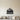 Black Rocky Mountain Peaks over Evergreens Metal Wall Art on a light wall