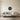 Sea urchin metal wall art hanging on a bathroom wall