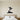 Black steel silhouette of a snowboarder above mountain peaks