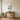 Standing Poodle Outline metal wall art hanging in a living room above a side table