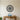 Round metal wall art of a succulent rosette with layered pointed leaves
