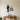 Silhouette of a teacher beside a stack of books with an apple on top