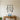 Black metal wall art of three fishing lures hanging from a bar