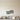 Black steel wall art of a piano keyboard bending in a soft wave