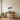 Wavy piano keys metal wall art hanging above an upright piano in a living room