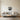 Whale tail metal wall art hanging in a bedroom