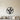 Black metal wall art of wheat stalks and grass blades inside a circle
